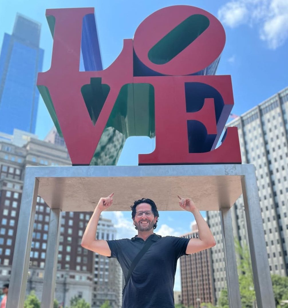 Andrew Emma, Manager of Love Park, in front of the LOVE sculpture